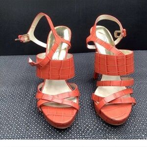 Michael Kors Nadja platform sandals in mandarin embossed leather.